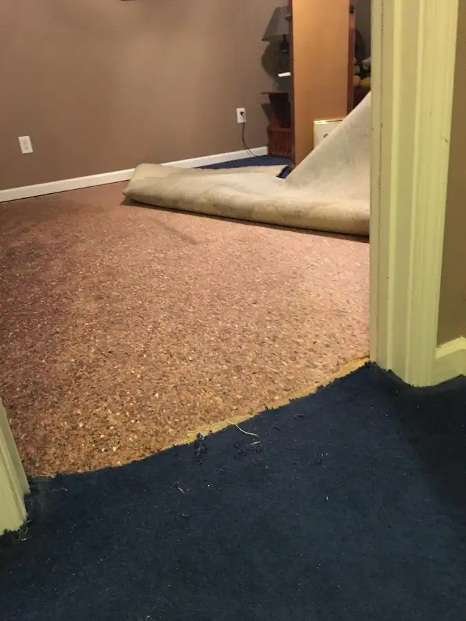 Carpet pad removal revealing water damage during Water Mitigation Services in White Rock